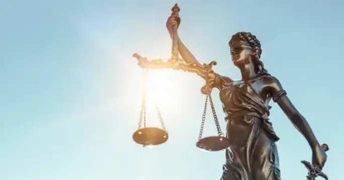 A statue of justice holding a scale, symbolizing fairness and accountability in the aftermath of the Horizon IT scandal.