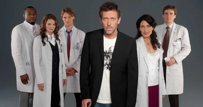 A group of doctors in white coats, Portraying the Gregory House MD cast.