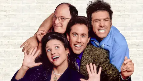 a group of people posing for a photo the main cast from Seinfeld 